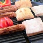 Grill sausage, pepper, garlic and toast ciabatta rolls
