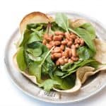 Add greens, pinto beans to taco shell